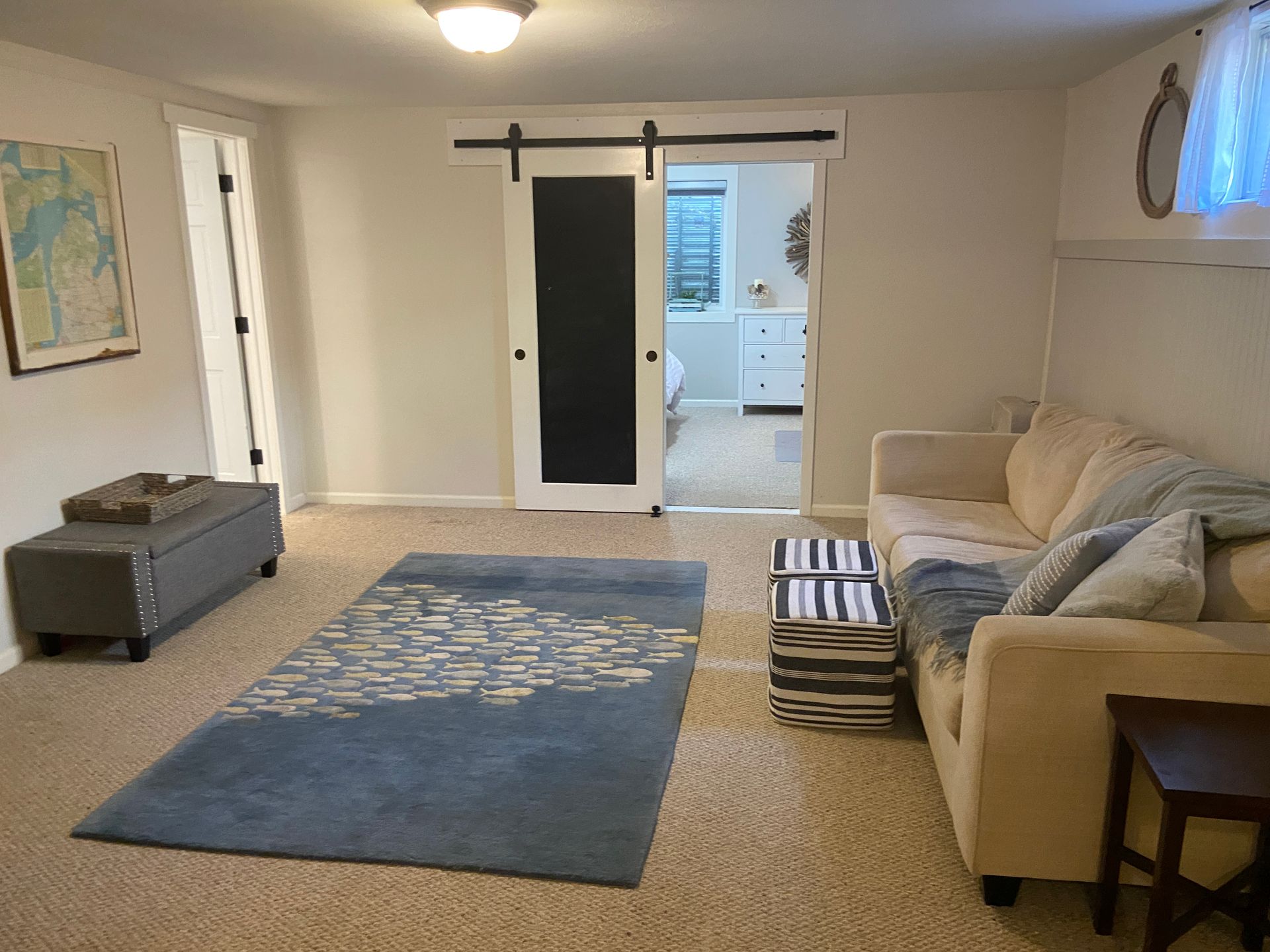 After Interior Design of Basement. Coastal Cottage Style with fish rug and chalkboard sliding door.