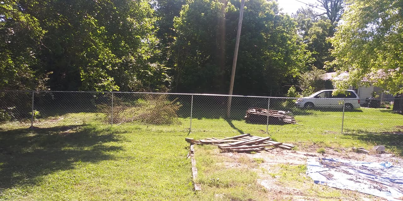 A white van is parked in the backyard of a house.