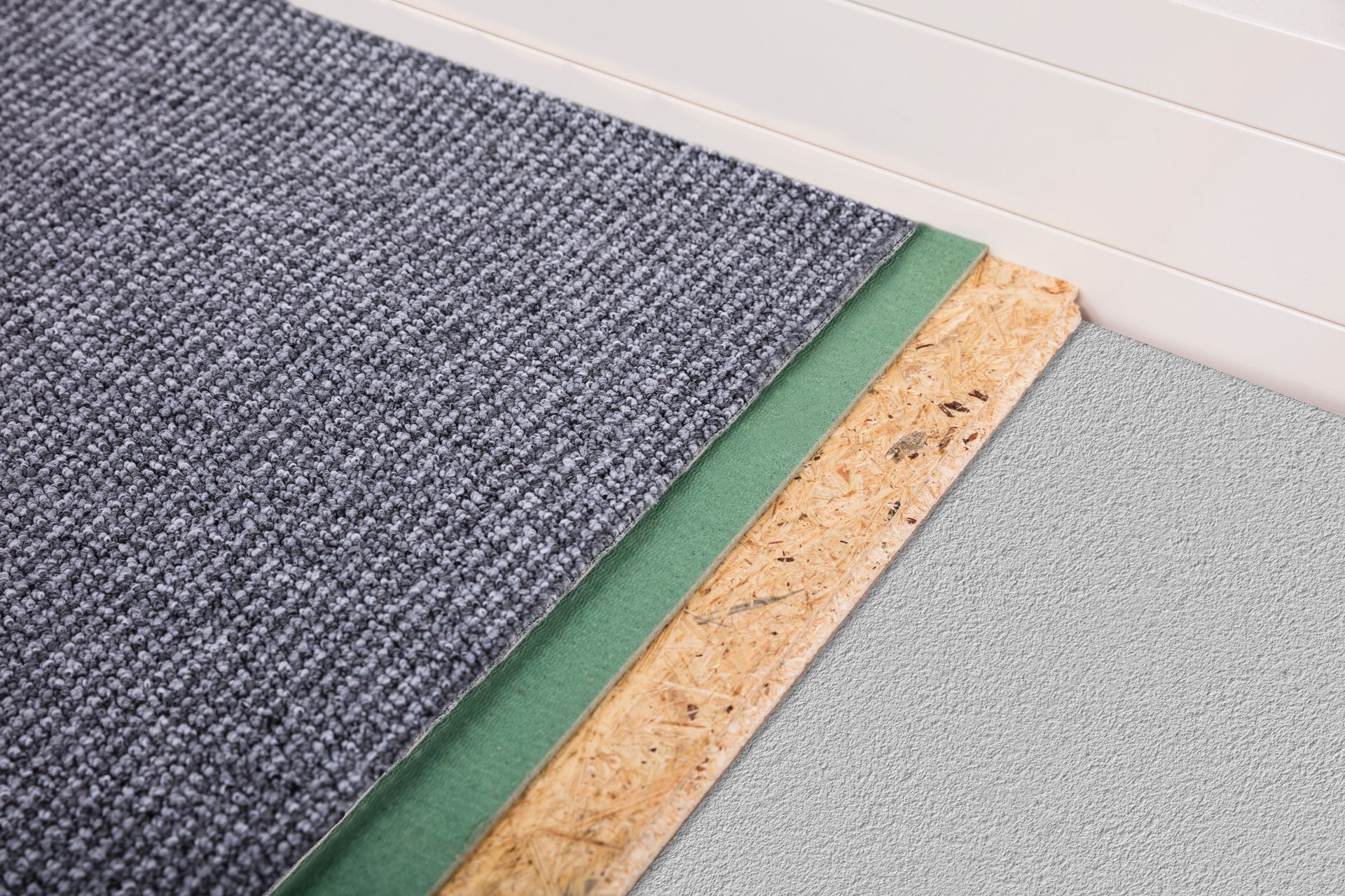 A close up of a carpet being installed on a floor.
