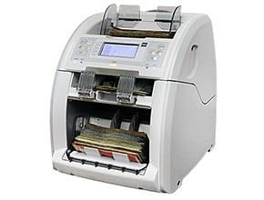 A machine that is counting money on a white background.