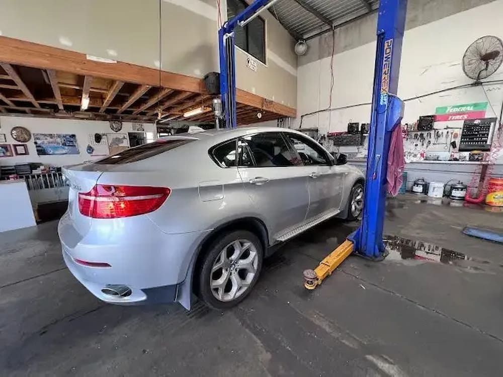 A Car Is Sitting On A Lift In A Garage — Banora Automotive In Tweed Heads South, NSW