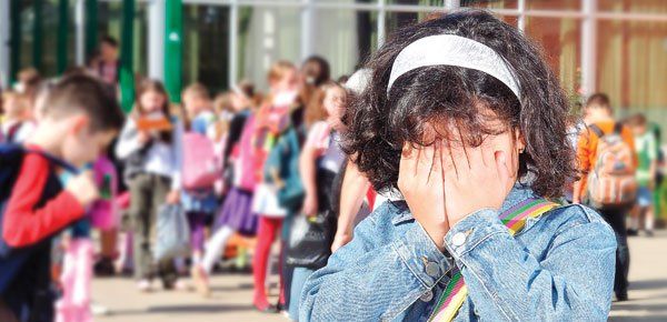 Girl covering her face and not wanting to goto school