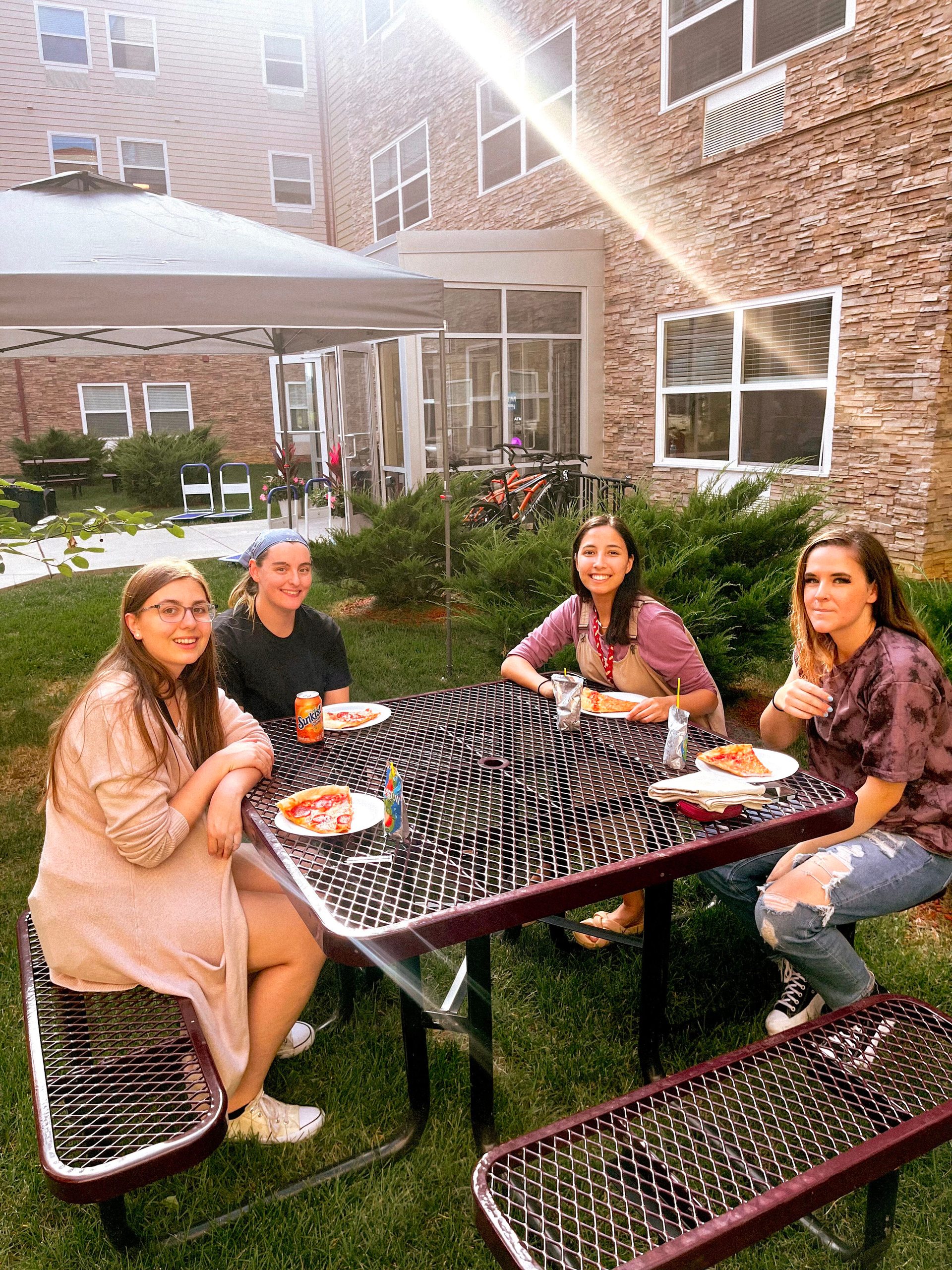 friends eating around picnic table