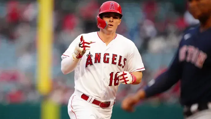 a baseball player for the LA Angels is running on the field .