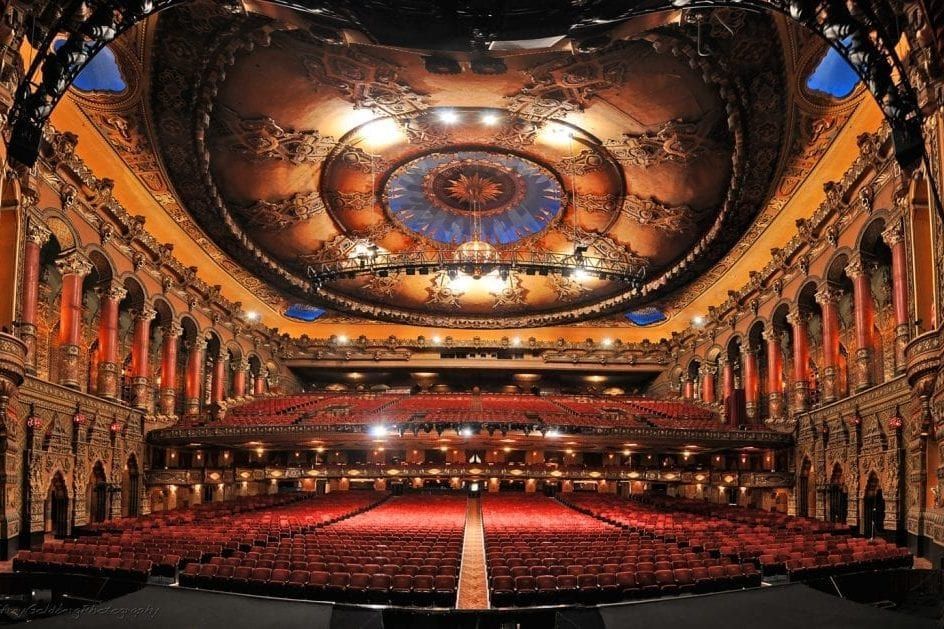 a group of people standing outside of the crypto.com arena