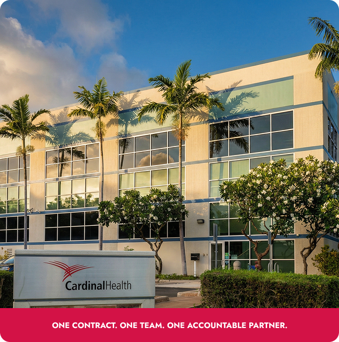 Cardinal Health office building with palm trees and a red sign reading “ONE CONTRACT. ONE TEAM. ONE ACCOUNTABLE PARTNER.”