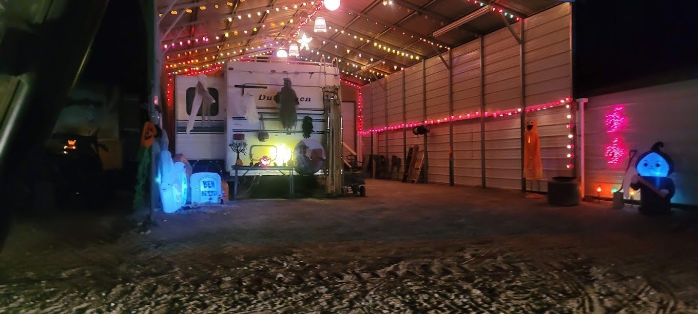 A rv is parked in a garage decorated for halloween.