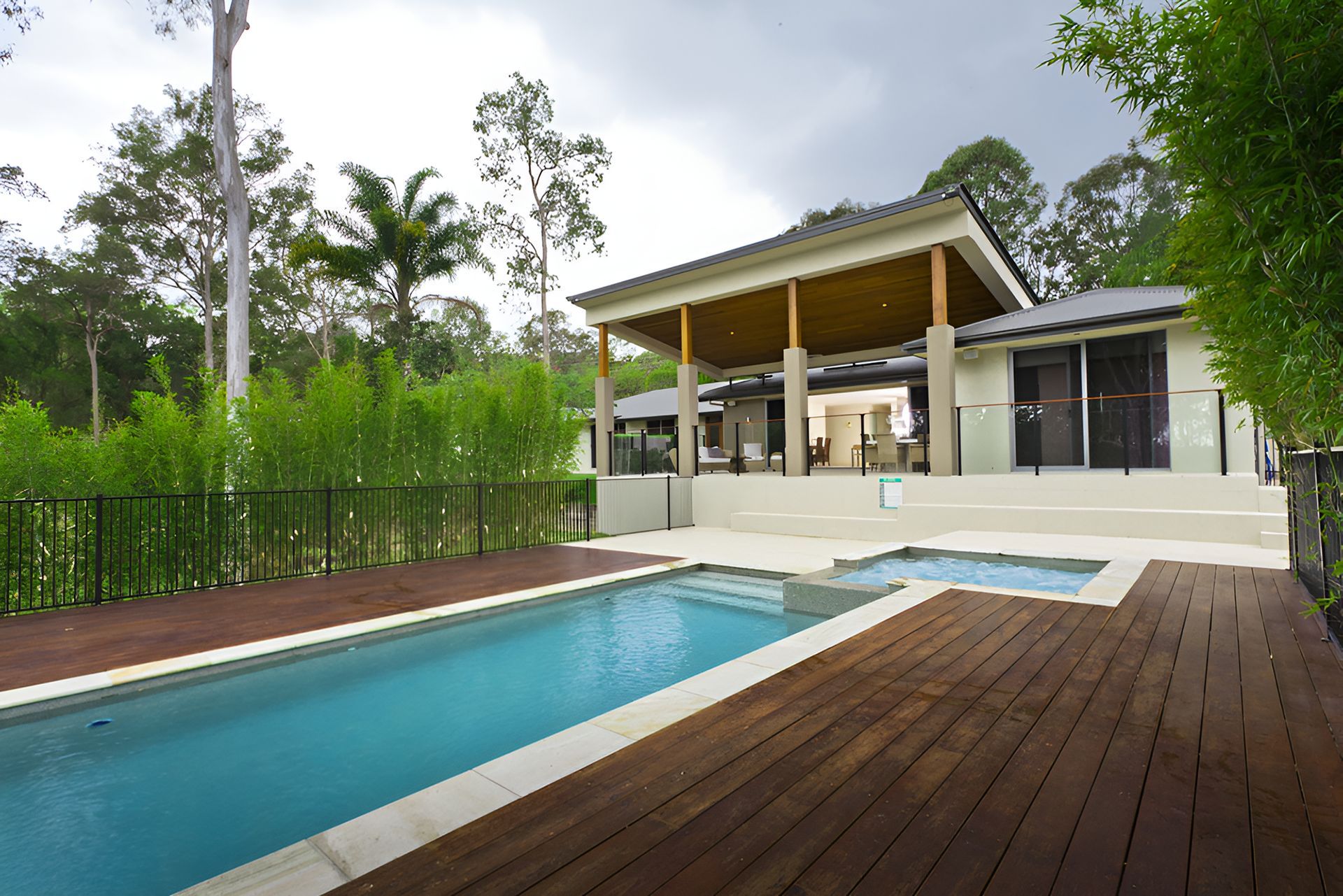 Two Construction Workers Are Working On The Roof Of A Building  — Harris Design & Building Concepts In Jubilee Pocket, QLD
