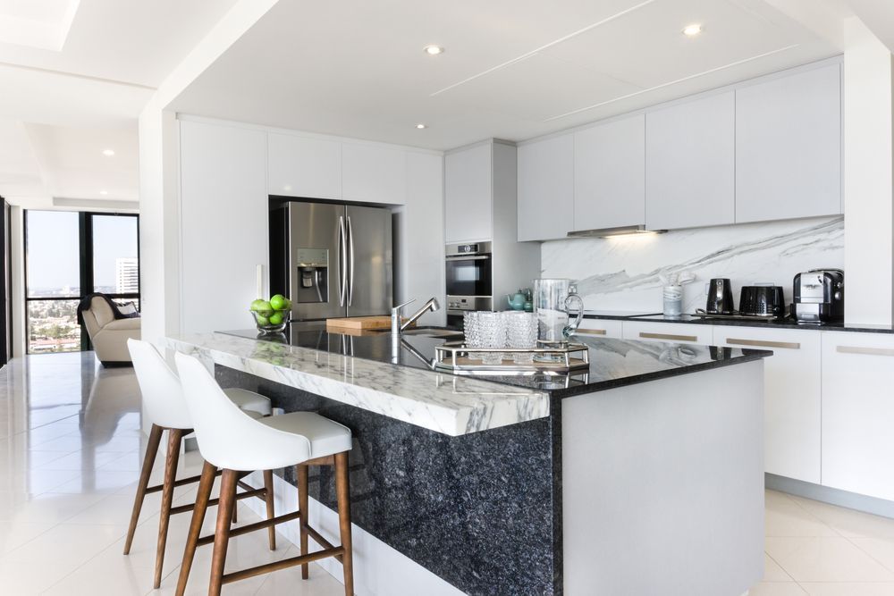 A Kitchen With White Cabinets — Harris Design & Building Concepts In Whitsunday Region, QLD