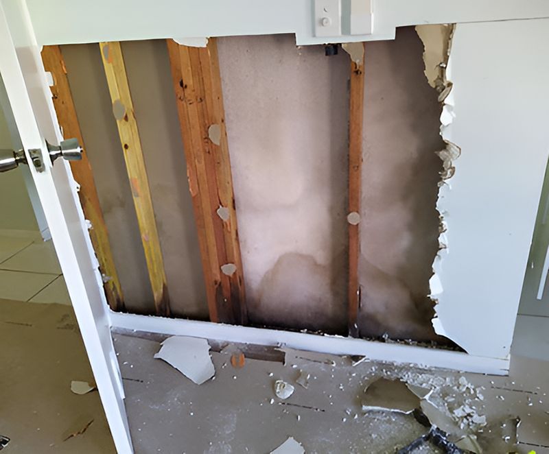 A Wall With A Hole In It Is Being Remodeled — Harris Design & Building Concepts In Jubilee Pocket, QLD