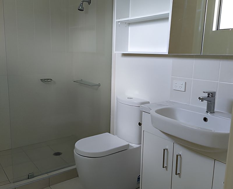 A Bathroom With A Toilet A Sink And A Shower — Harris Design & Building Concepts In Jubilee Pocket, QLD