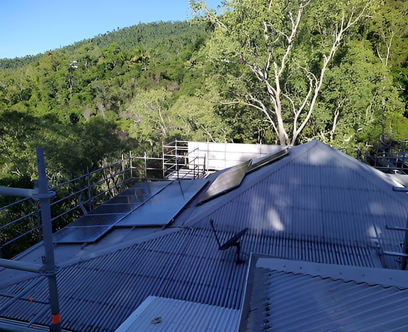 A Roof With Scaffolding On It And Trees In The Background — Harris Design & Building Concepts In Jubilee Pocket, QLD