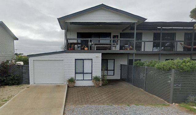 A Large White House With A Garage And A Balcony — Harris Design & Building Concepts In Jubilee Pocket, QLD