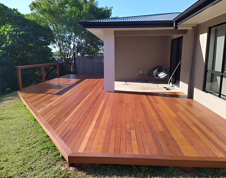 A Large Wooden Deck In Front Of A House — Harris Design & Building Concepts In Jubilee Pocket, QLD