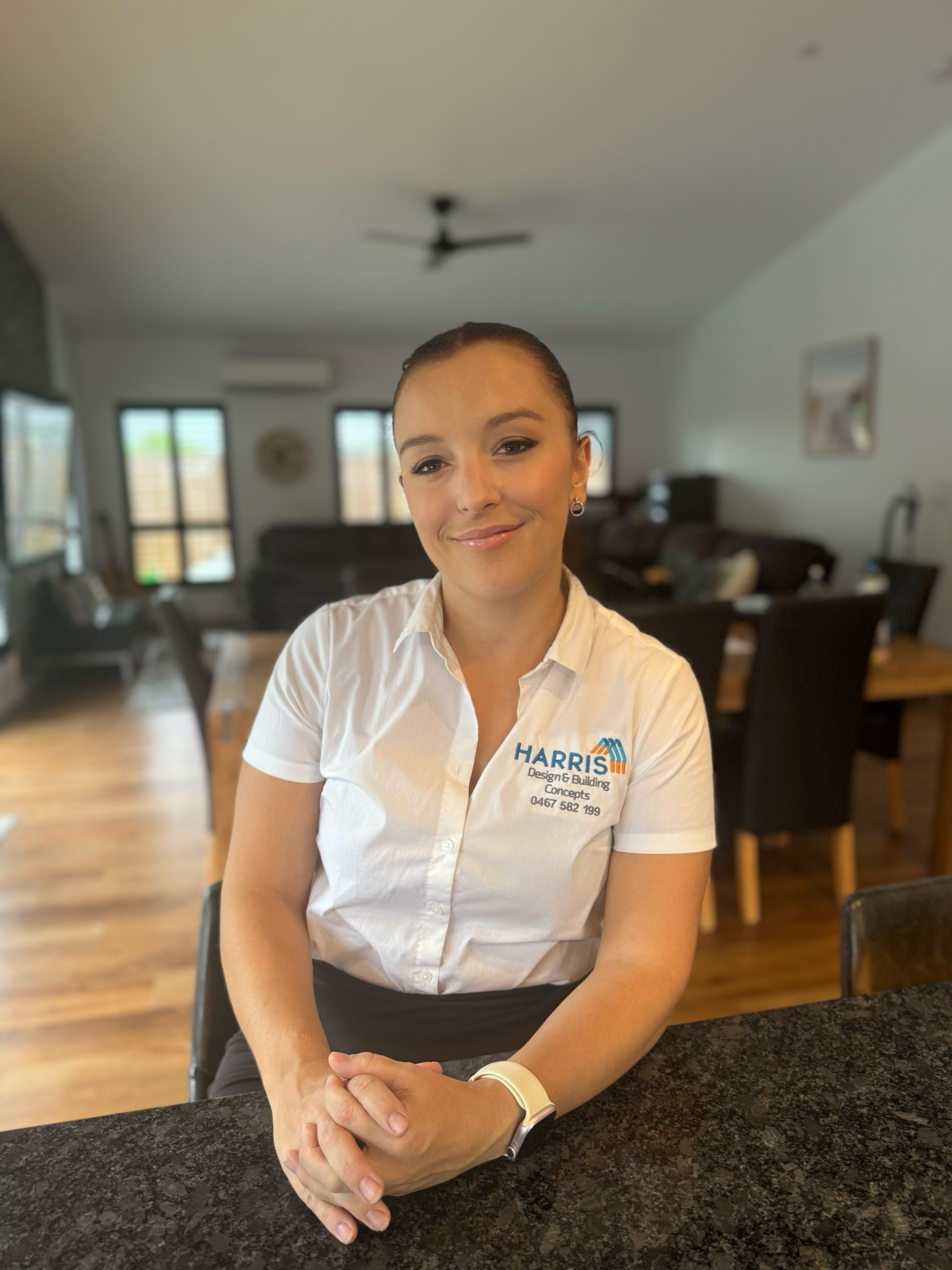A Living Room With A White Sectional Couch And A Black Chair — Harris Design & Building Concepts In Jubilee Pocket, QLD