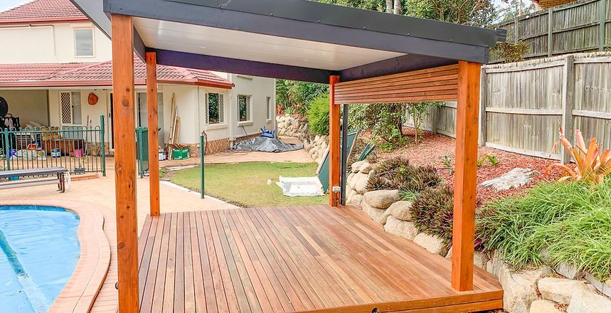 A Wooden Deck With A Pergola Over It Next To A Swimming Pool — Harris Design & Building Concepts In Jubilee Pocket, QLD