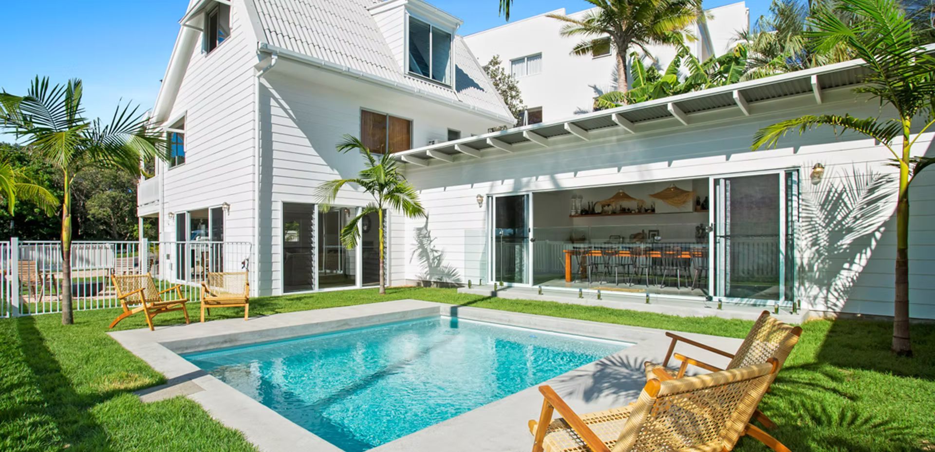 A Kitchen With Black Counter Tops And White Cabinets — Harris Design & Building Concepts In Jubilee Pocket, QLD
