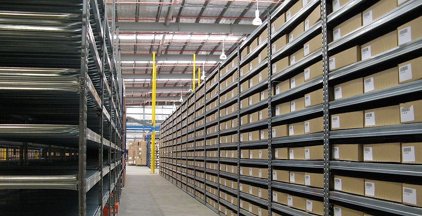 A Warehouse Filled With Lots Of Shelves And Boxes — Harris Design & Building Concepts In Jubilee Pocket, QLD