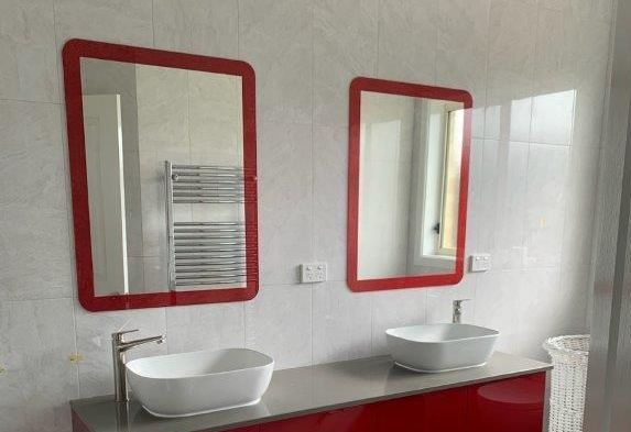 A bathroom with two sinks and two mirrors