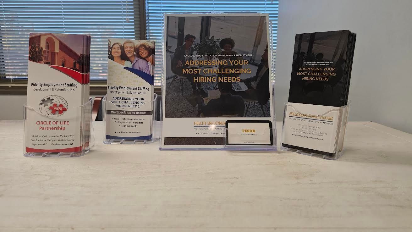 Brochures in holders on a table. Background of window blinds.
