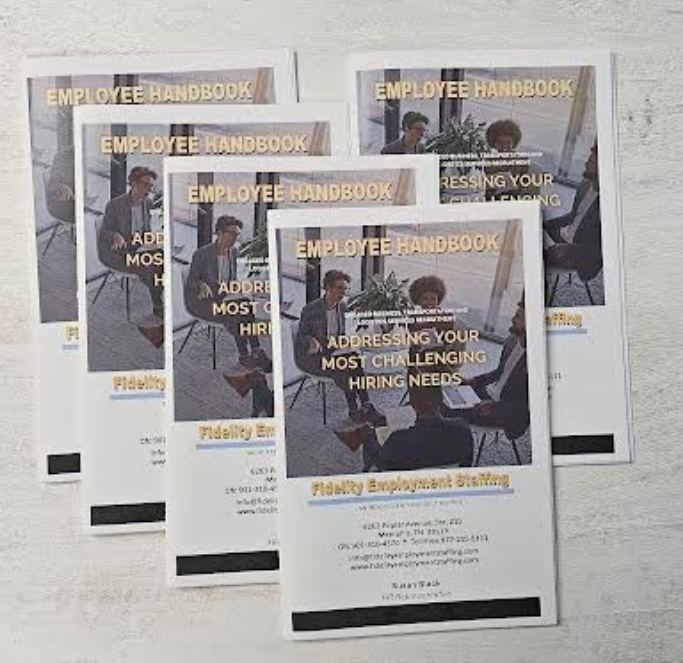 Stack of printed cards with a photo, text, and black border on a white surface.