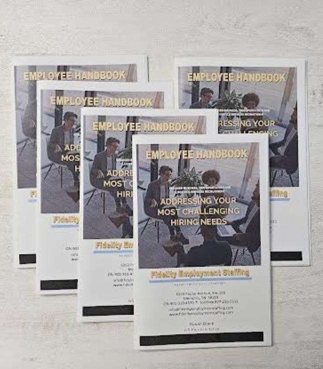 Pile of white printed cards featuring an image and text on a textured, white surface.