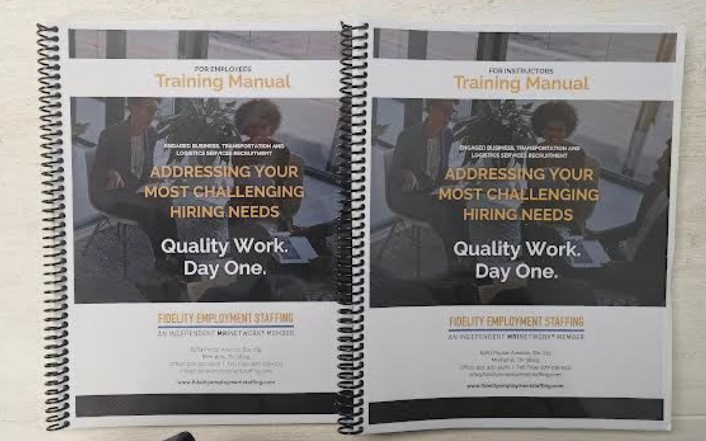 Two spiral-bound training manuals labeled