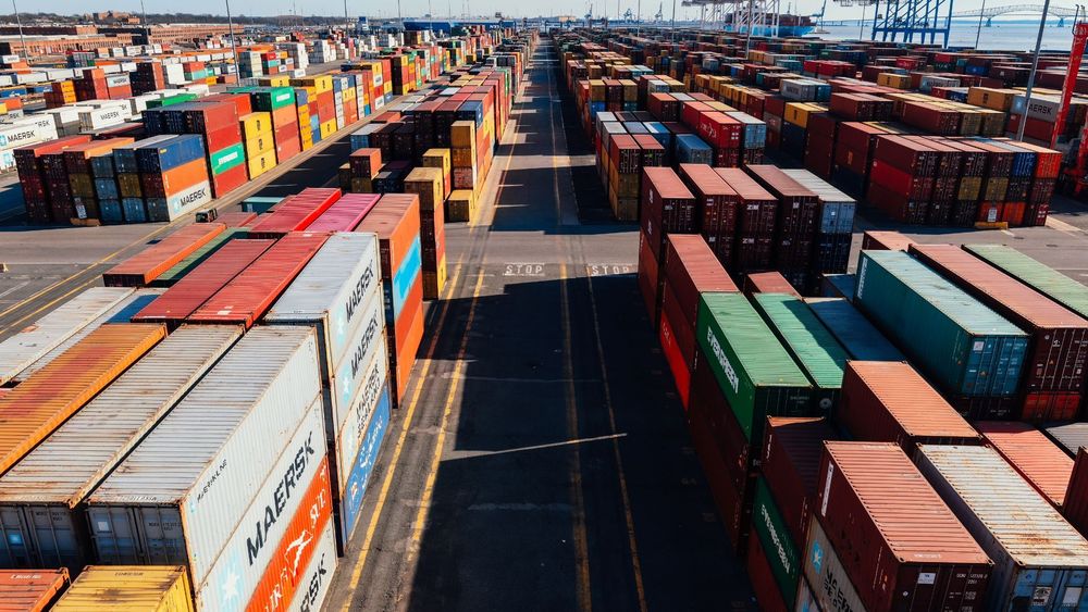 Rows of colorful shipping containers at a port.
