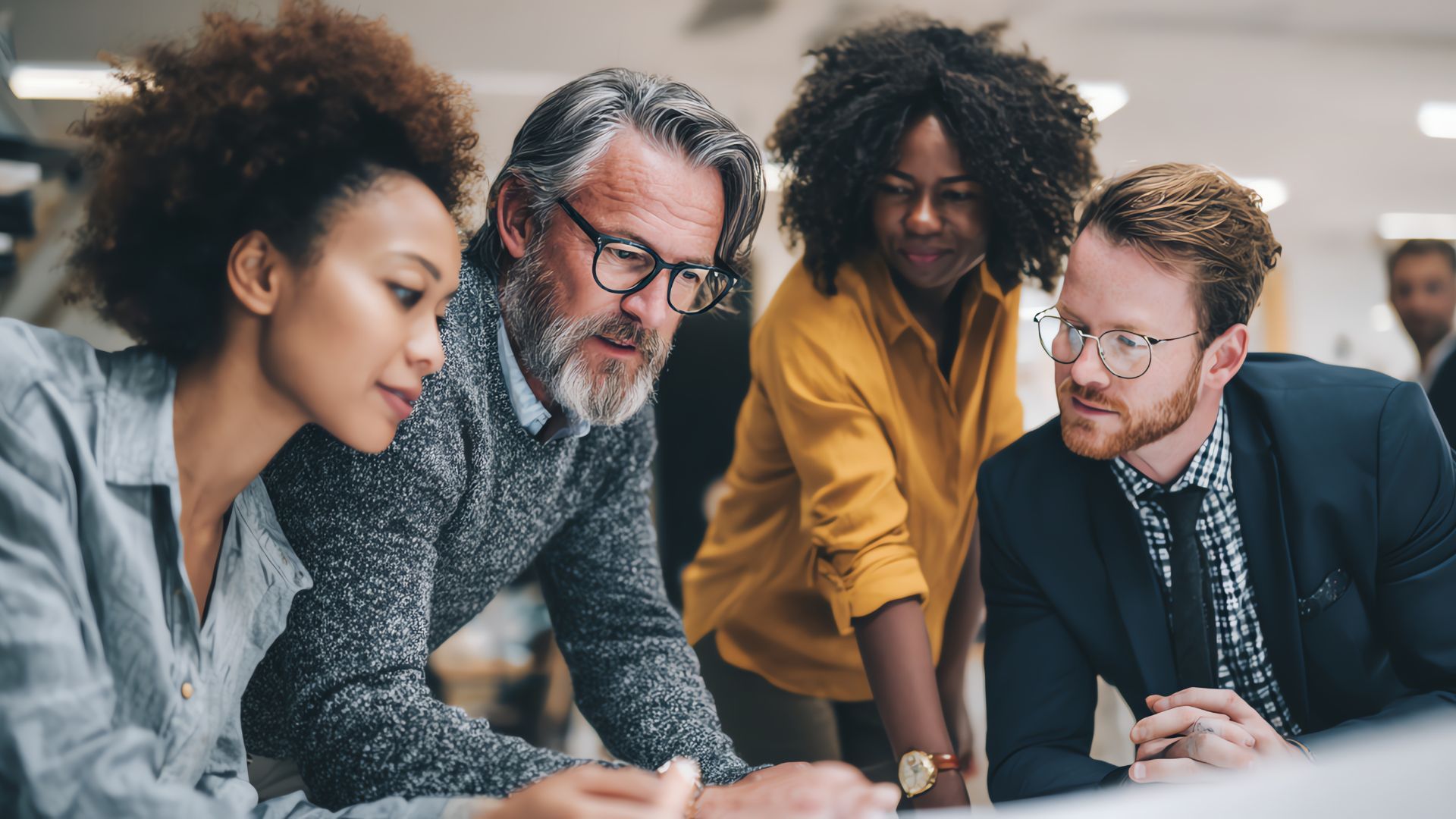 Four coworkers collaborating, focused on a document. Modern office setting.
