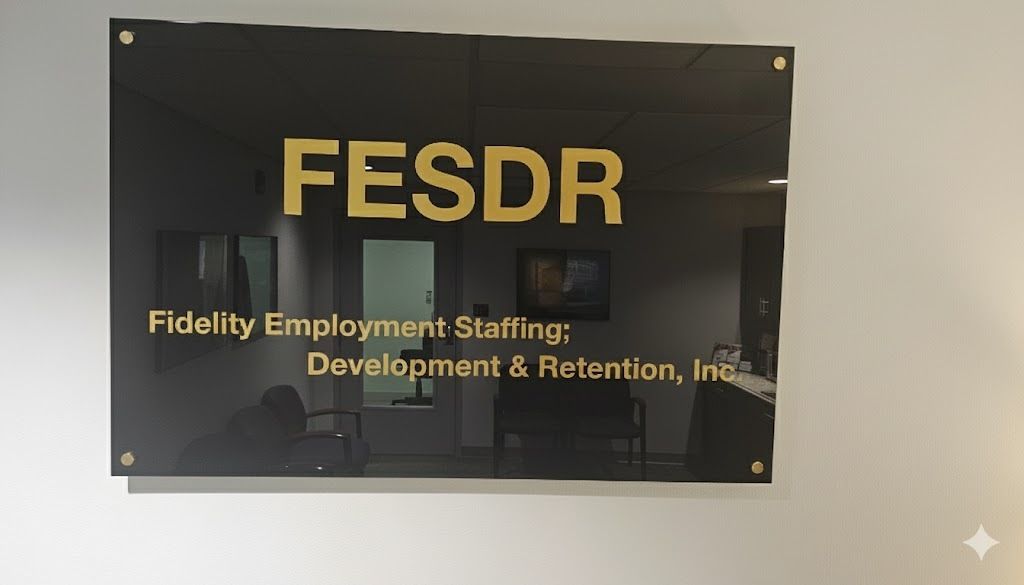 Sign for Fidelity Employment Staffing: Development & Retention, Inc. on a black background, gold lettering.