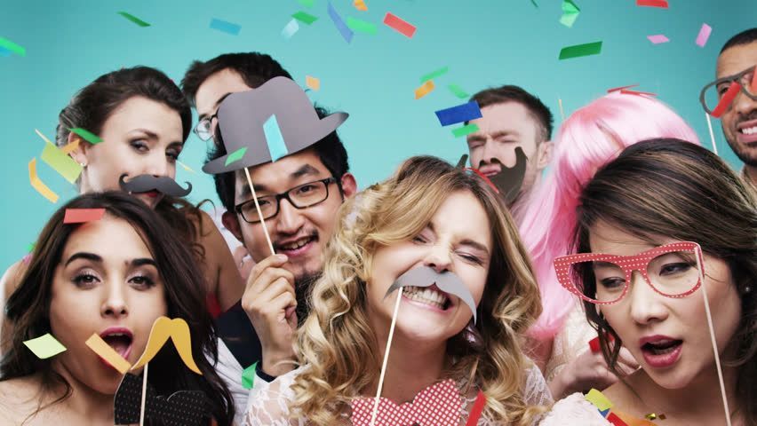 A group of people are posing for a picture in a photo booth.