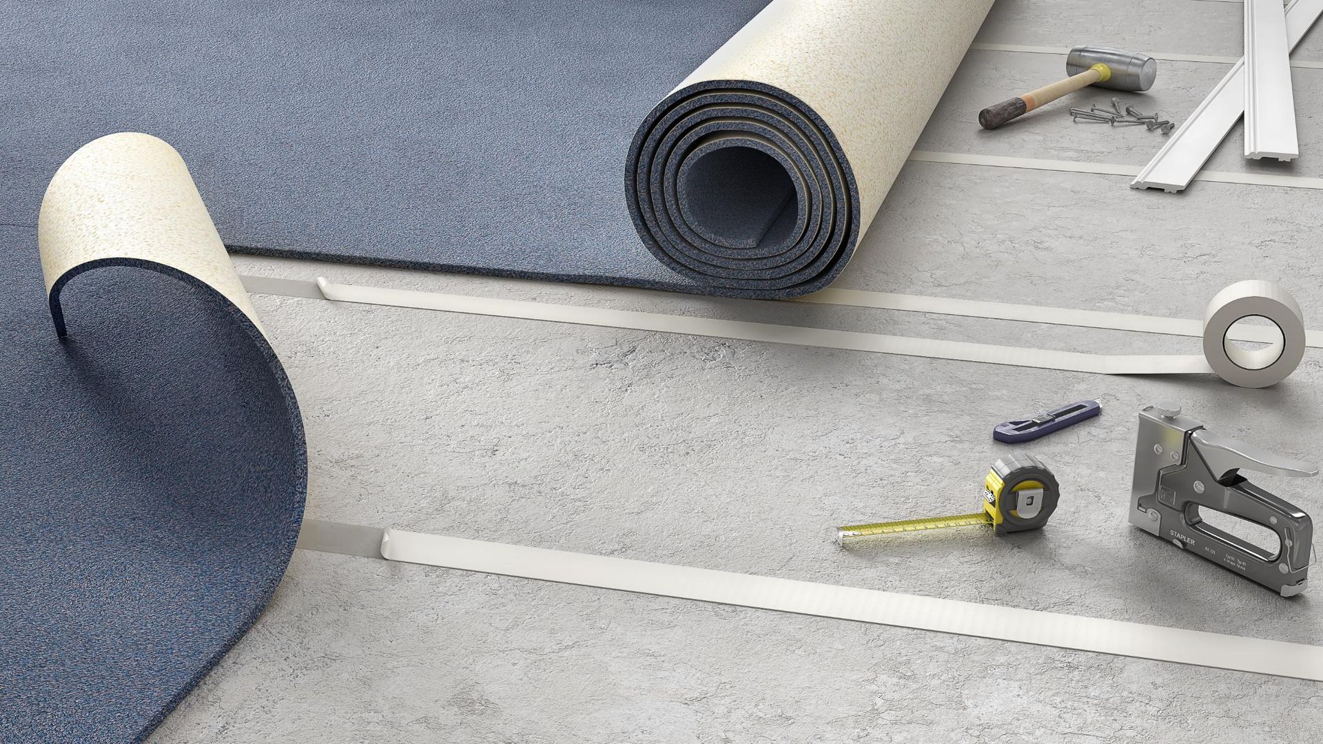 Carpet installation: Blue carpet roll, adhesive tape, tools on concrete floor.