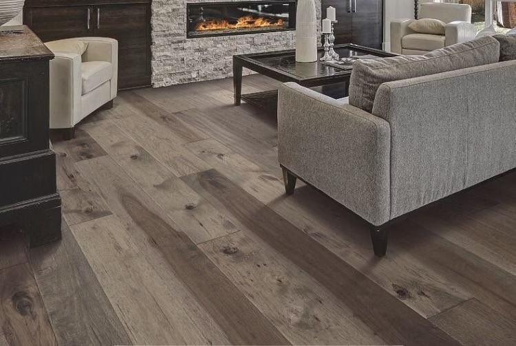 Living room with wood floor, fireplace, sofa, and armchair.