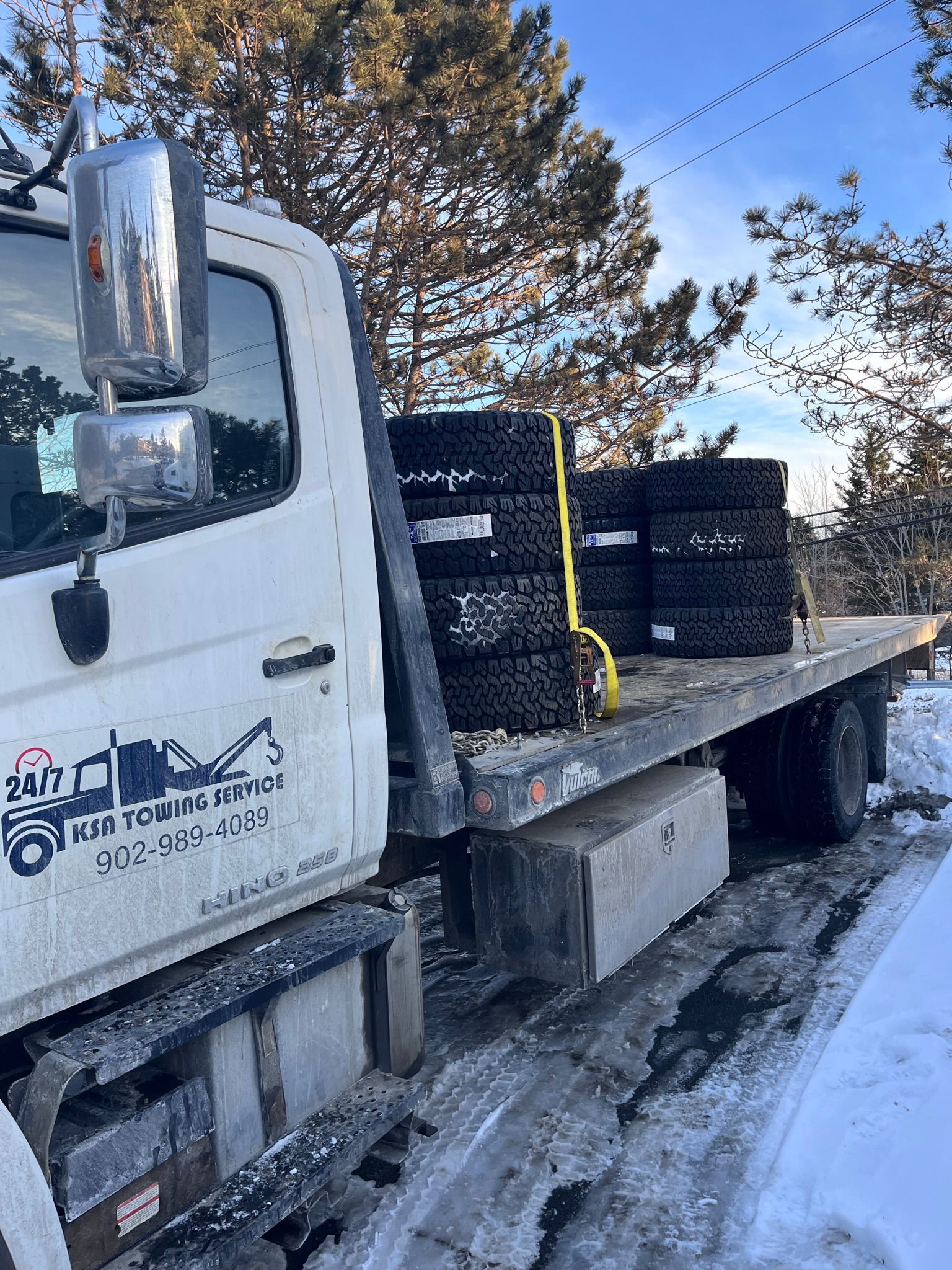 A tow truck delivering tires