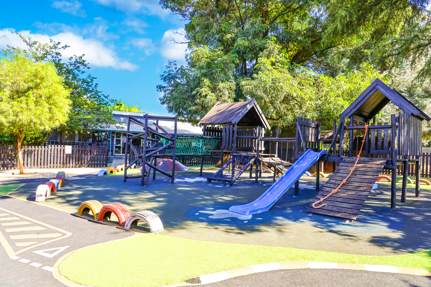 A playground in a park with a blue sky in the background