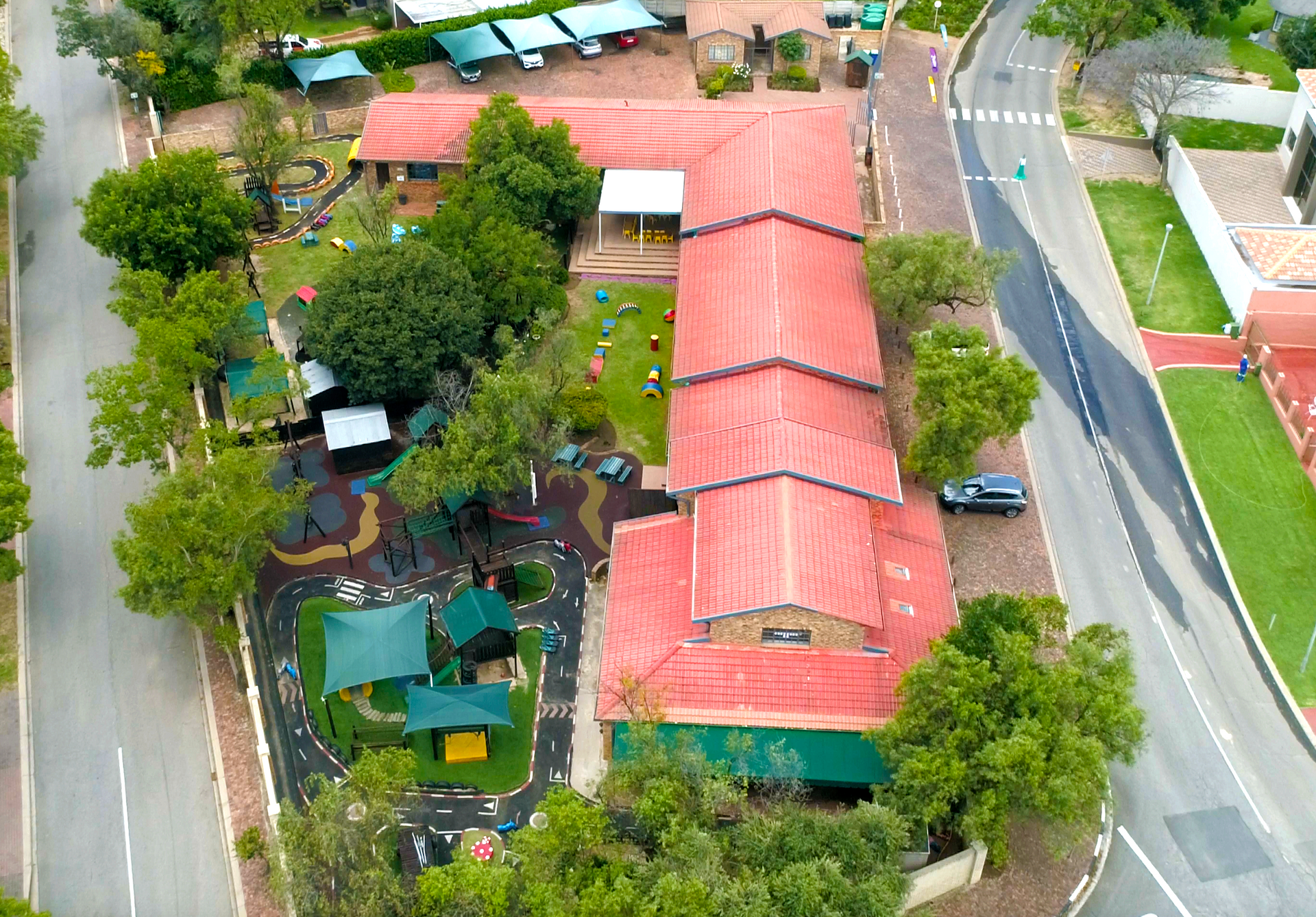 An aerial view of a house with a red roof