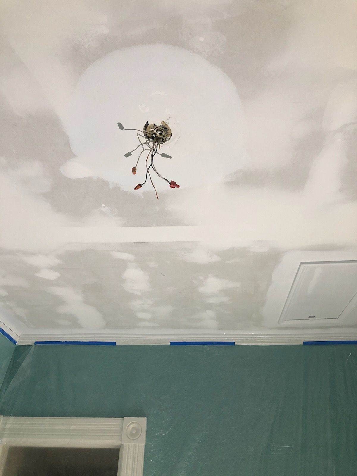 A chandelier is hanging from the ceiling of a room.