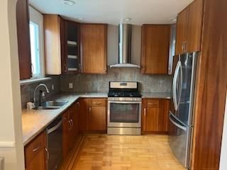 A kitchen with stainless steel appliances and wooden cabinets.