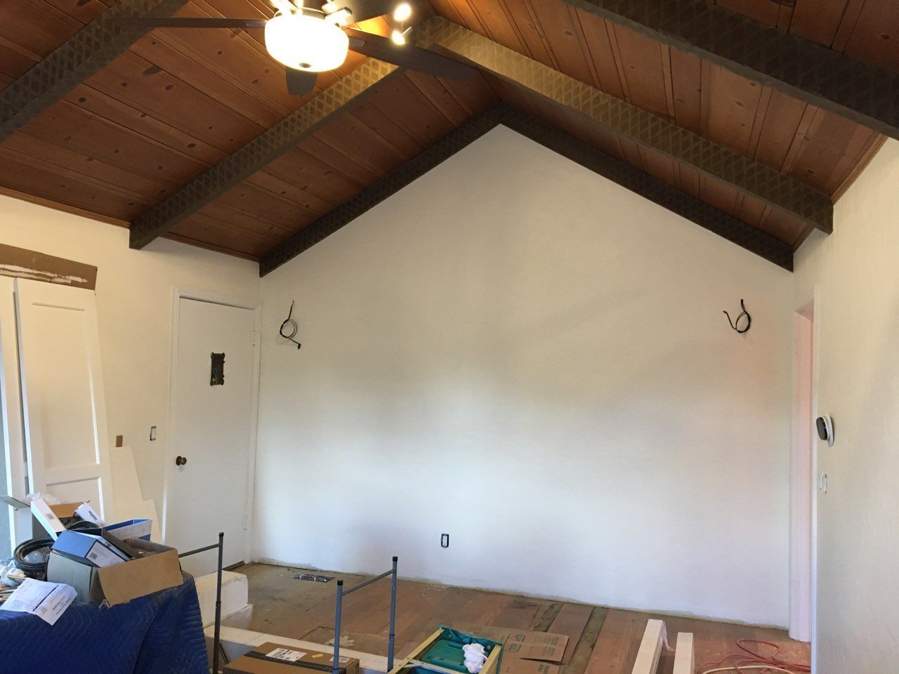 A room with a vaulted ceiling and white walls