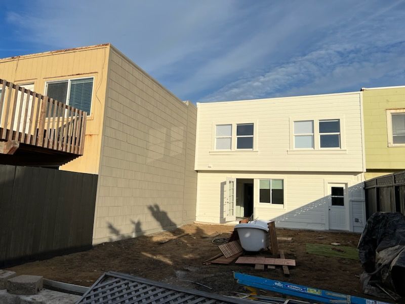 A row of houses are being built and one of them has a deck