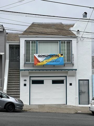 A white house with a sign that says home painting