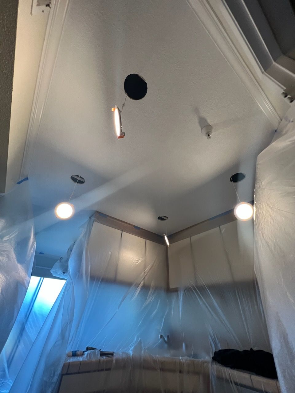 A kitchen with a ceiling that is covered in plastic