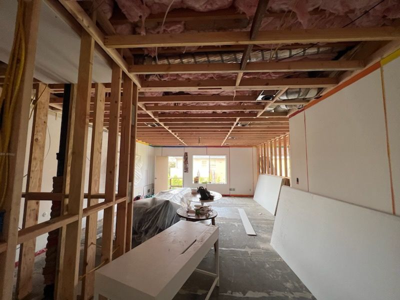 A living room under construction with a couch and a table