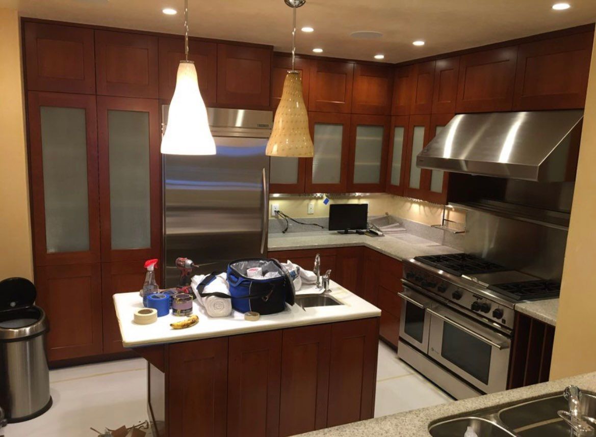 A kitchen with stainless steel appliances and wooden cabinets