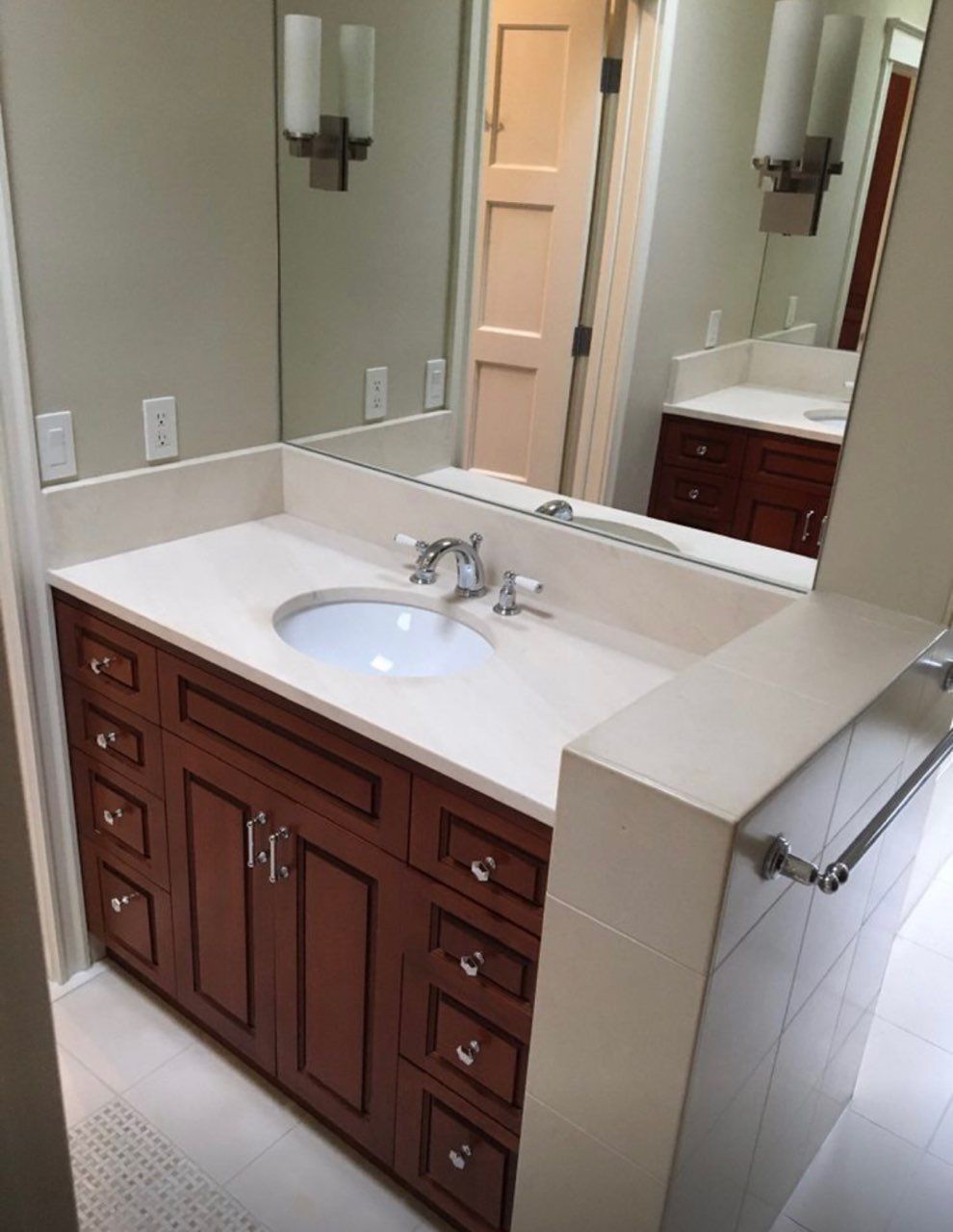 A bathroom with a sink and a large mirror