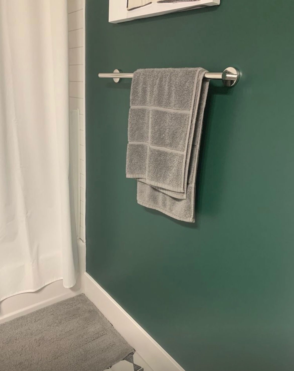Two towels are hanging on a towel rack in a bathroom.