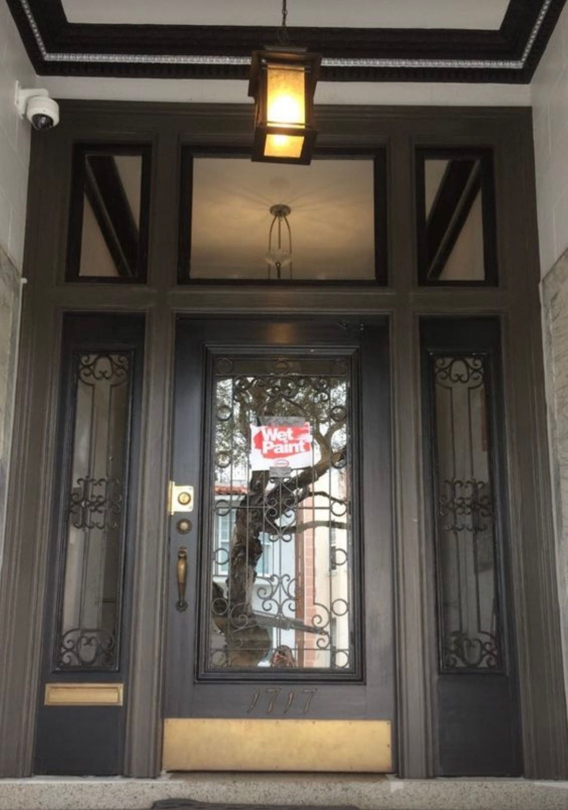 The front door of a building with a sign that says for rent