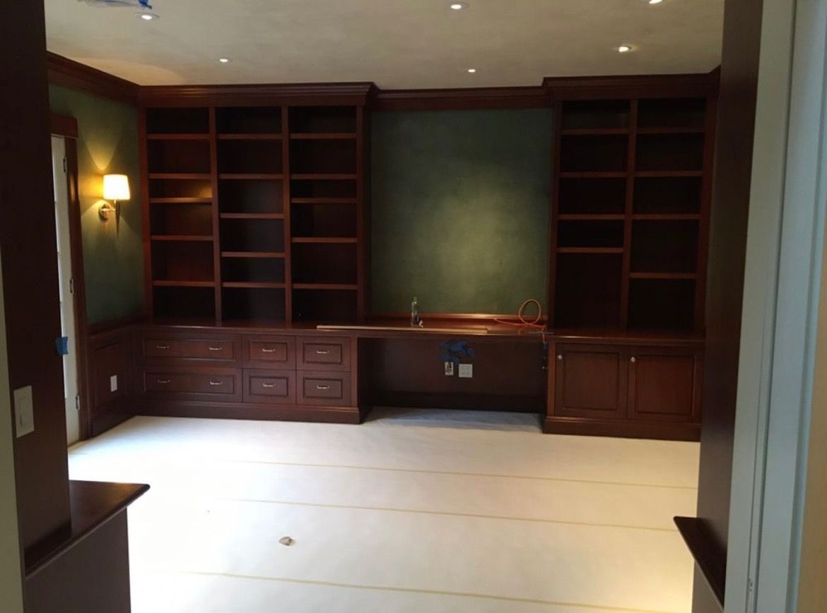 An empty room with lots of shelves and drawers