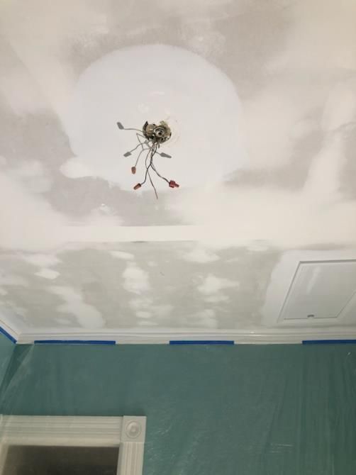 A chandelier is hanging from the ceiling of a room.