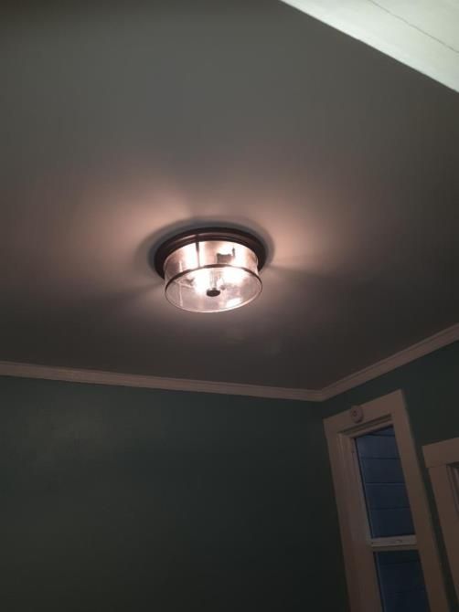 A ceiling light in a room with a window